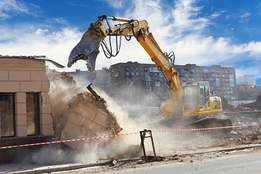 machine demolishing a house